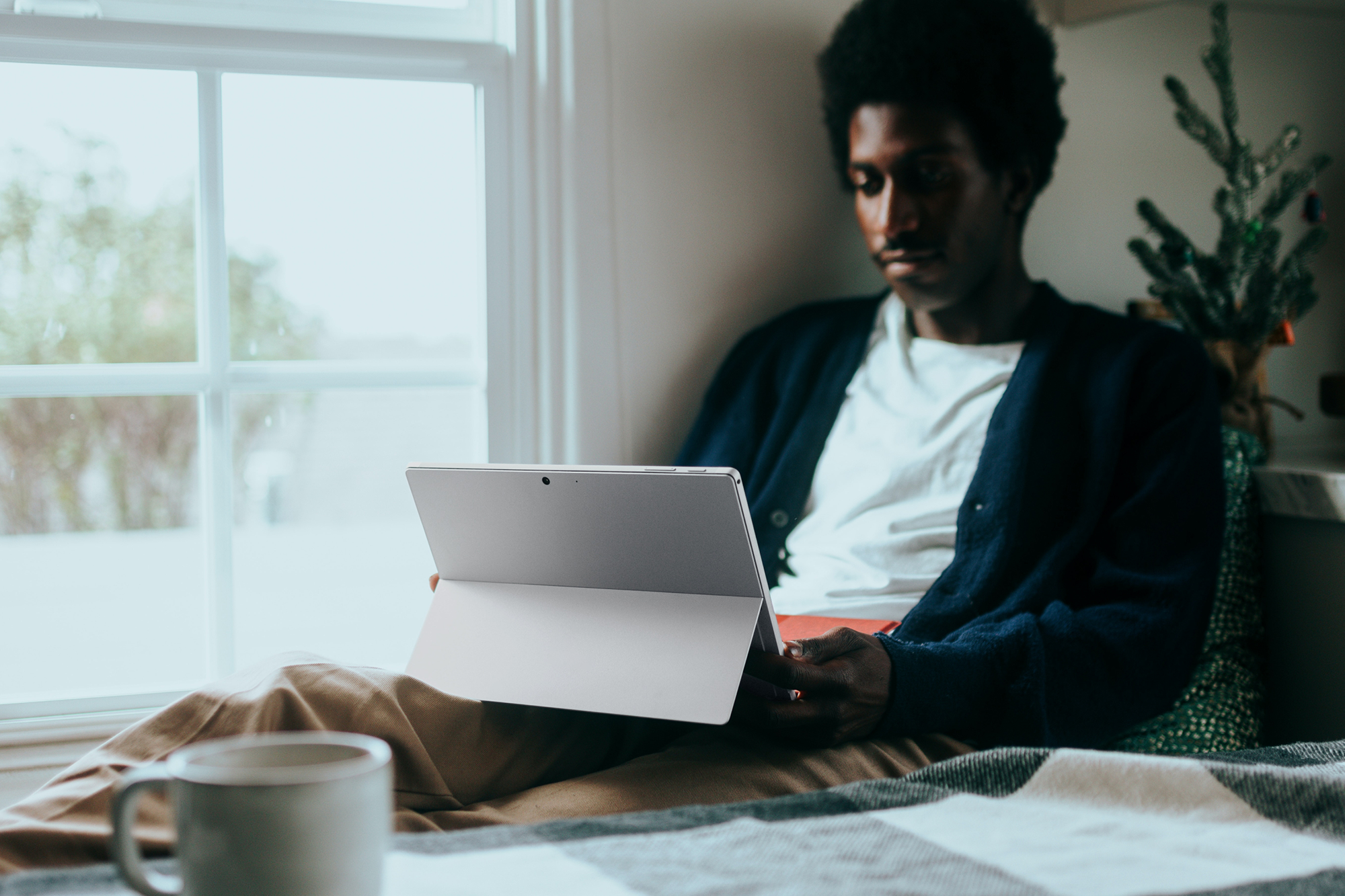 A person sits working at their computer, struggling to focus